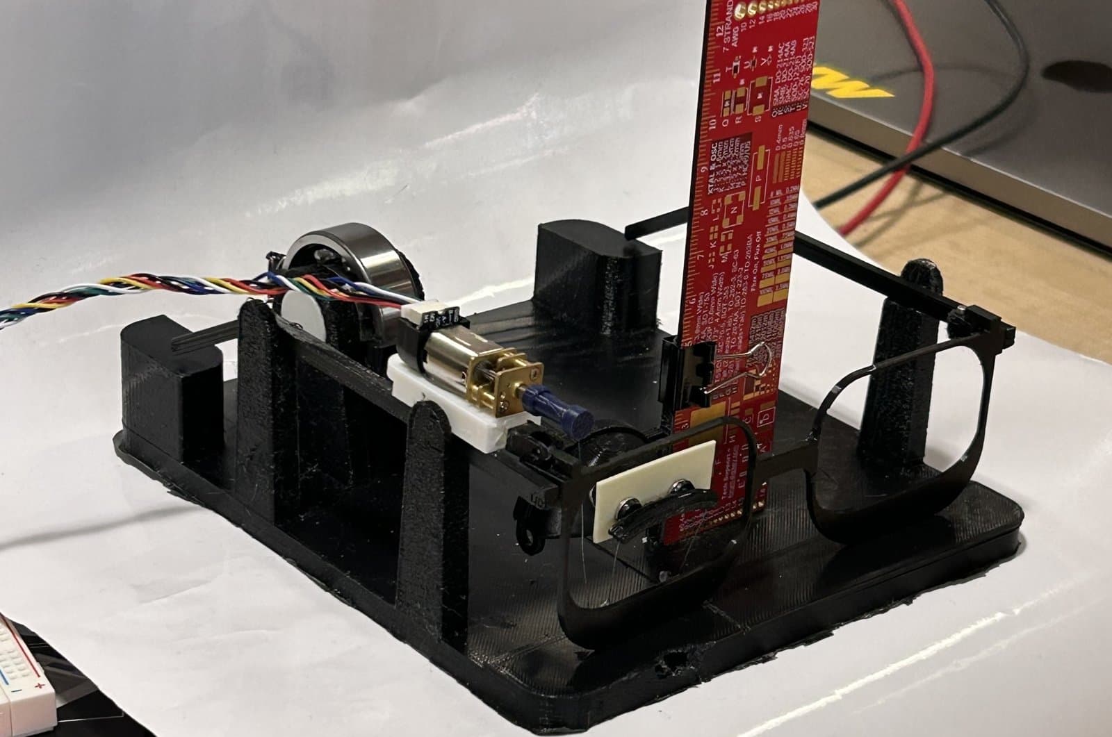 Pulley-based eyelid movement prototype on a workbench